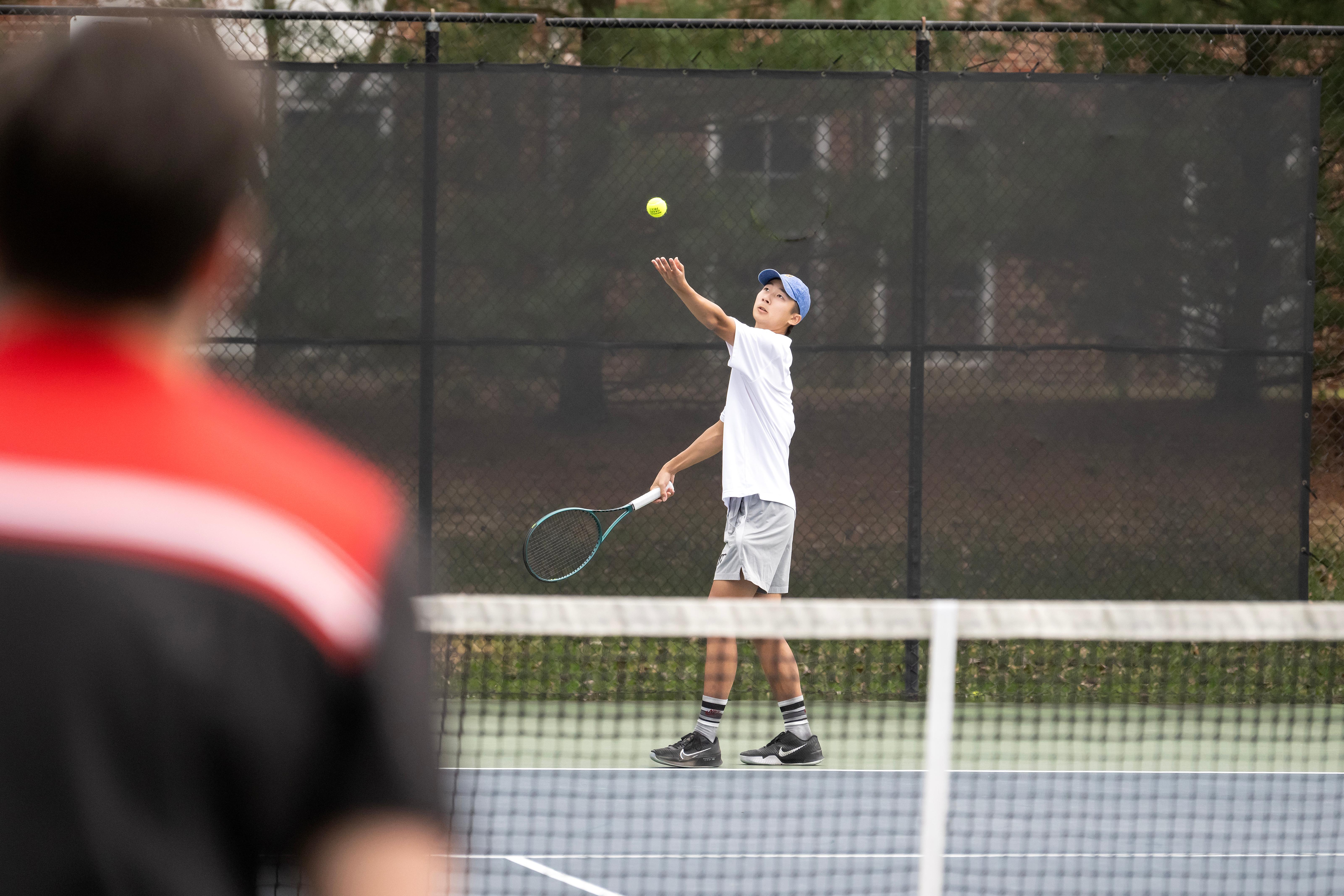 Two WC students playing tennis