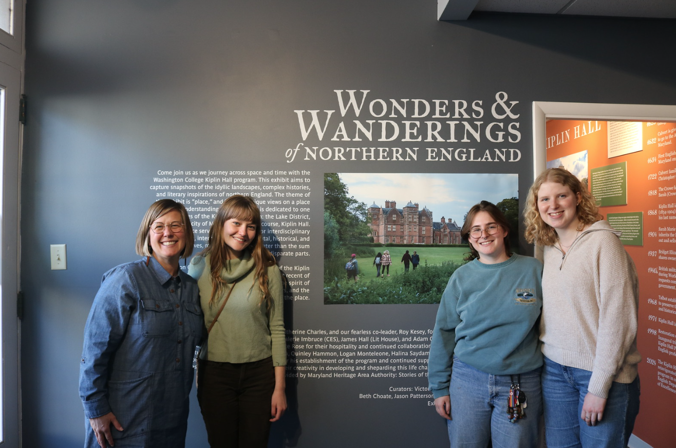 students and beth standing in exhibit at muse