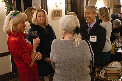 a small group in a circle talk during a holiday party