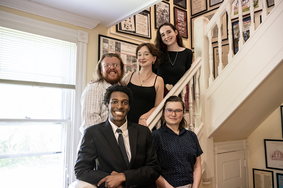 The 2024 finalists for the Sophie Kerr Prize stand on the stairs in the Rose O'Neill Literary House