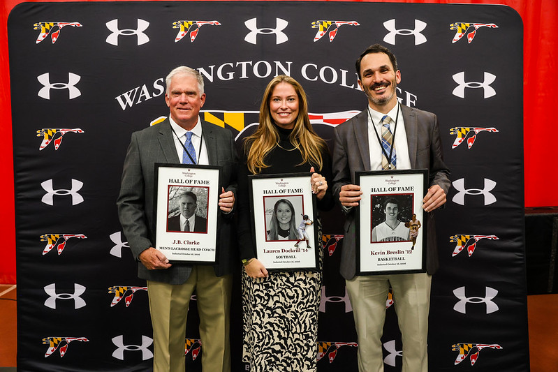 the new members of the Washington College Athletics Hall of Fame hold up their recognition plaques