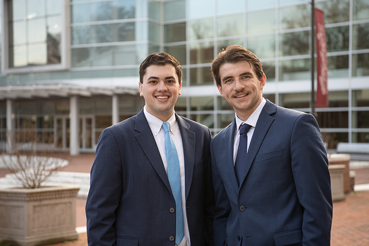 Stephen Hook '25 and Zach Affeldt '25 smile for a portrait in front of Gibson Center for the Arts.