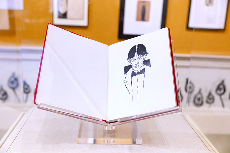 The loaned Beardsley book on display, open to a page with a pen-and-ink portrait