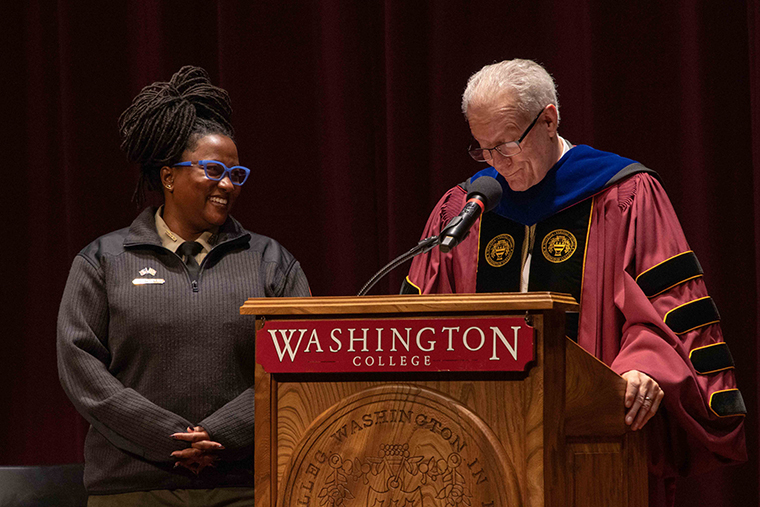 Ranger Angela Crenshaw '04 looks at President Bryan Matthews '75 as he presents her with the Washington College Award for Excellence