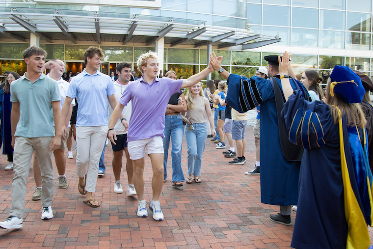 Class of 2029 students emerge to cheering professors following Washington College's Fall 2025 Convocation.