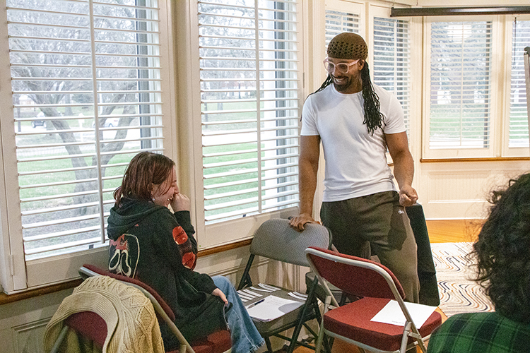 jericho brown laughs with a student during the duplex workshop