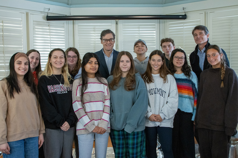 John Harwood (center in back) and Roy Kesey, Associate Director of Washington College's Rose O'Neill Literary House, (far right in back) join Washington College students for the Art of Rhetoric class following his appearance at the Richard L. Harwood Lecture in American Journalism .