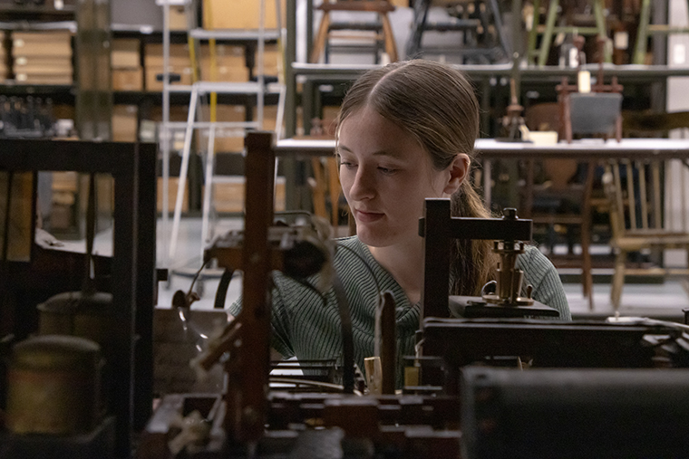 Cecilia Johnston ’27 looks at patent models in one of the Hagley museum’s storage areas