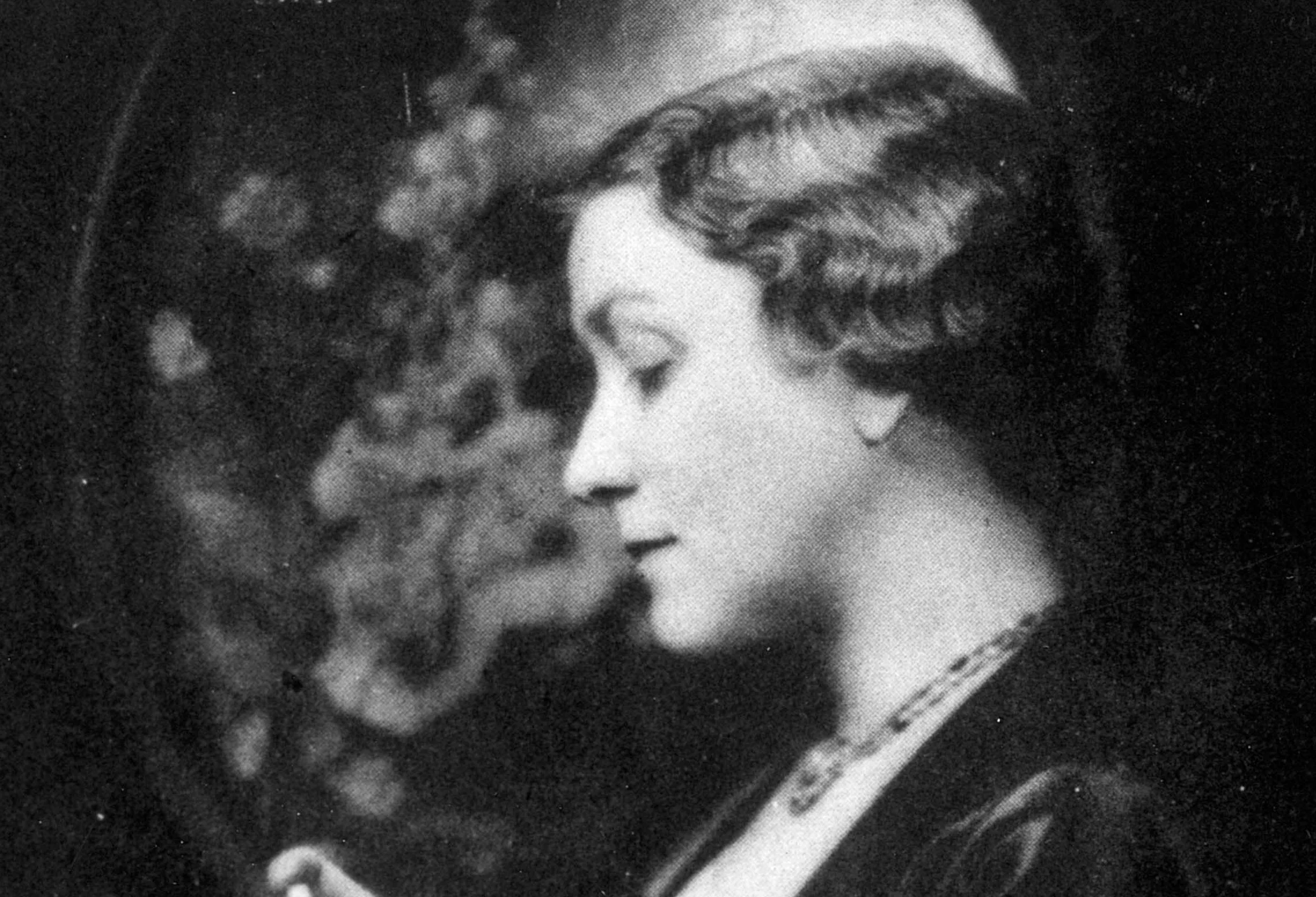 Sophie Kerr in profile in front of botanical art