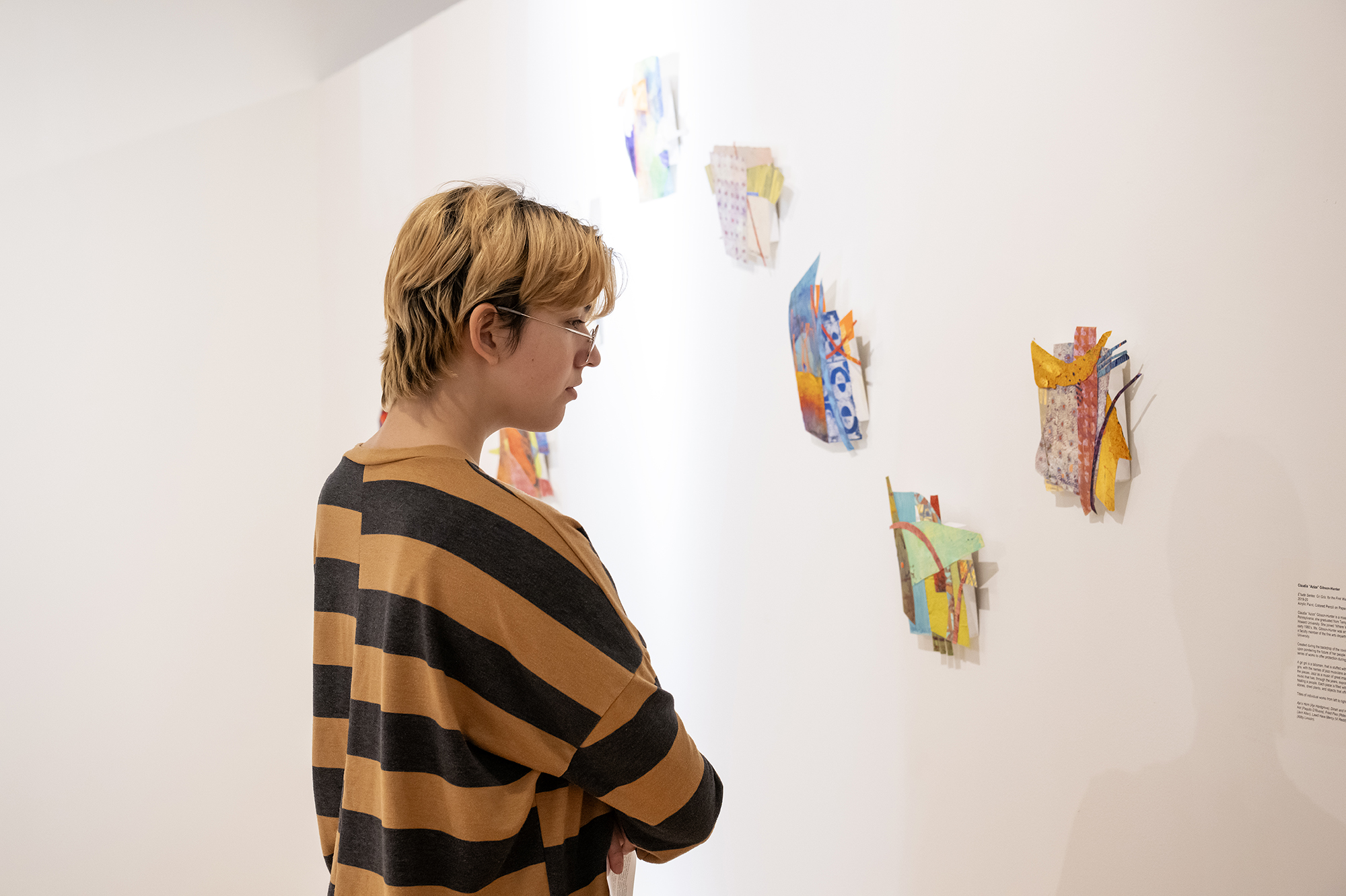 student looking at student artwork