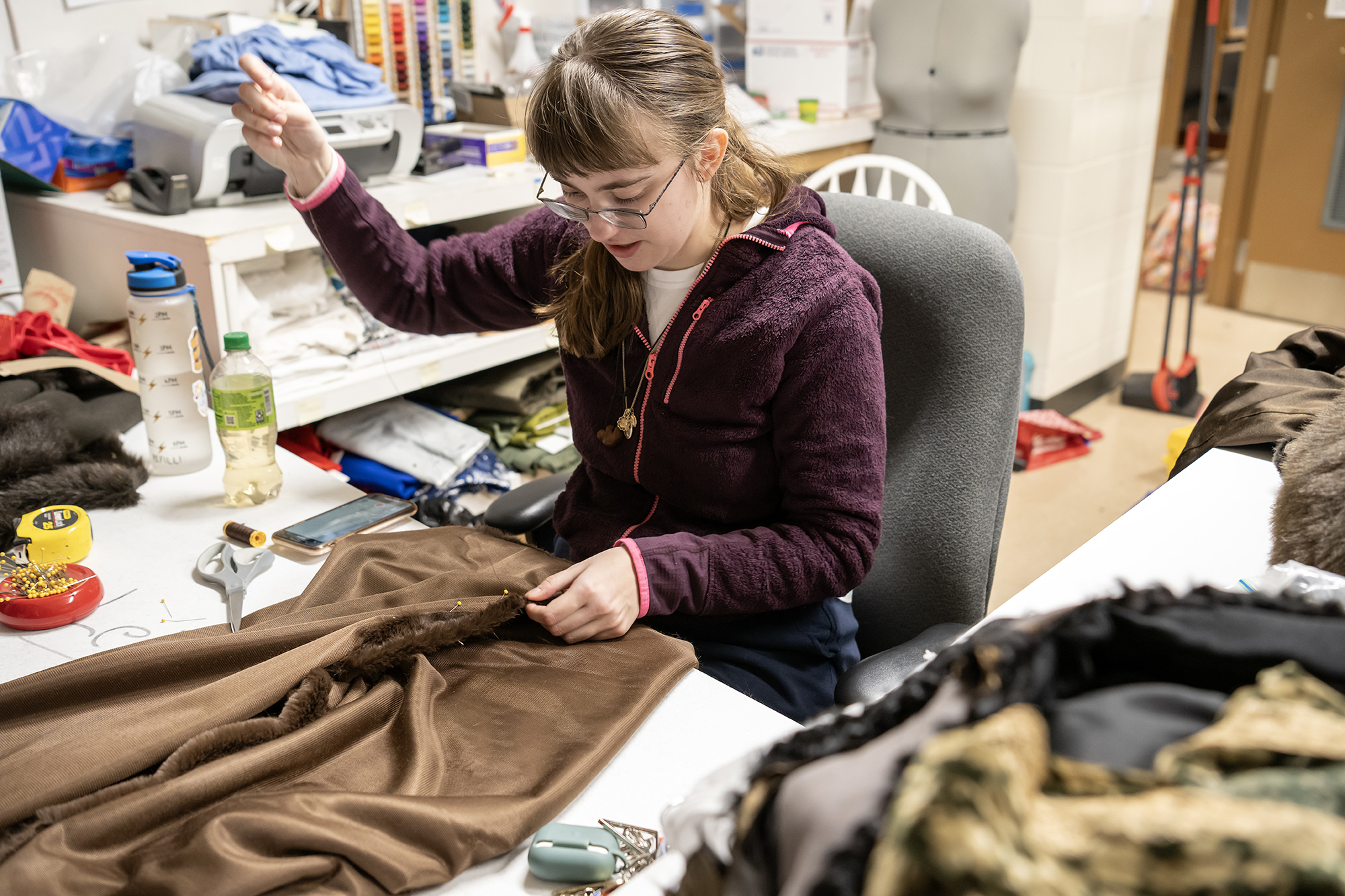 student working in the costume shop