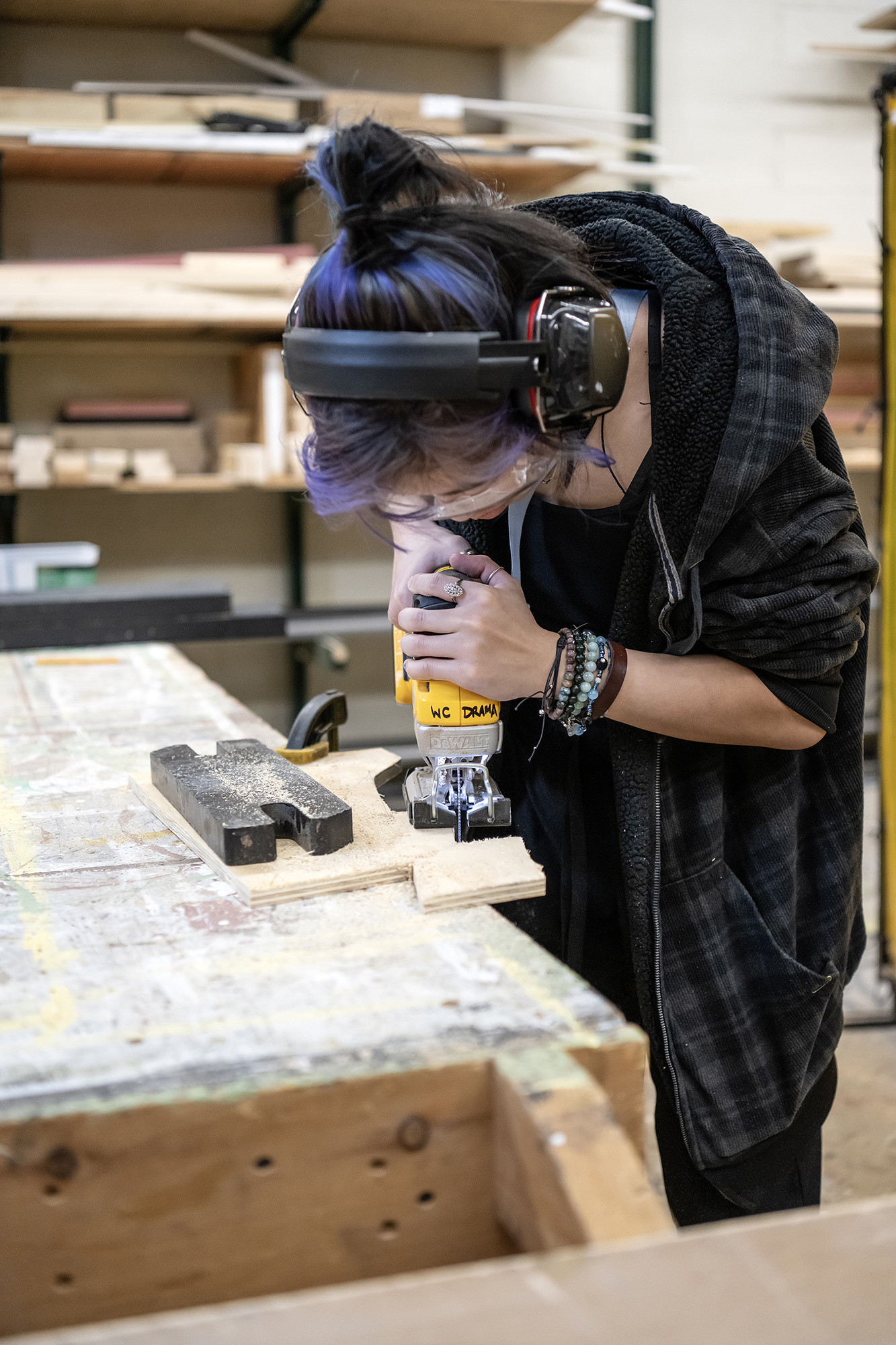 student working in the scene shop