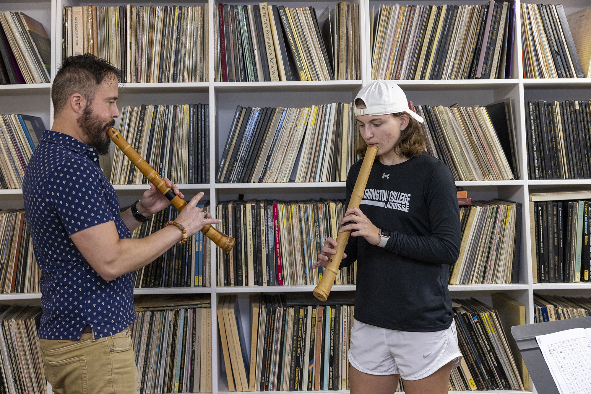 student and professor playing instruments