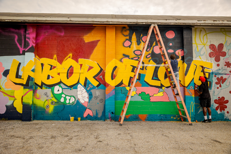 Mural artist Shelton Hawkins and Washington College student Evan Paddock (‘27) put the final touches on the “Labor of Love” mural currently on display at 800 High Street. Photo by Caroline J. Phillips. Mural artist Shelton Hawkins and Washington College student Evan Paddock (‘27) put the final touches on the “Labor of Love” mural currently on display at 800 High Street. Photo by Caroline J. Phillips.