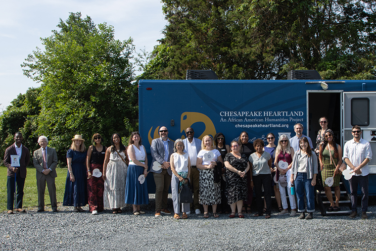 Participants in the June meeting of the Maryland Commission on Public Art stand in front of the Chesapeake Heartland mobile exhibit truck.