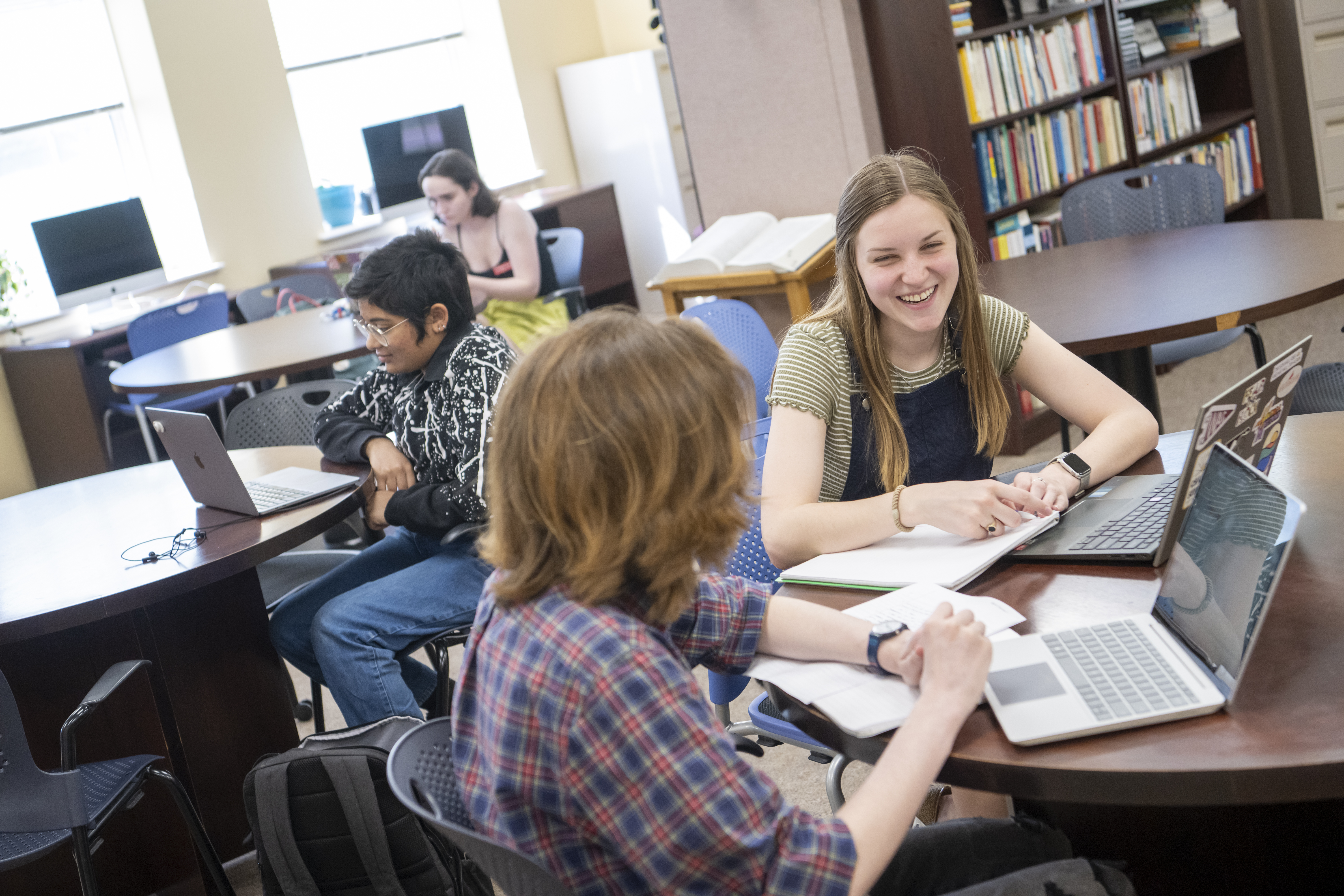 Interior photo of the Writing center with students working at several tables