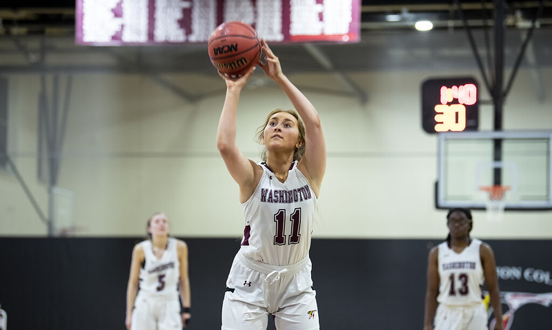 Avery, passing a basketball while playing on the WC Women's Basketball Team