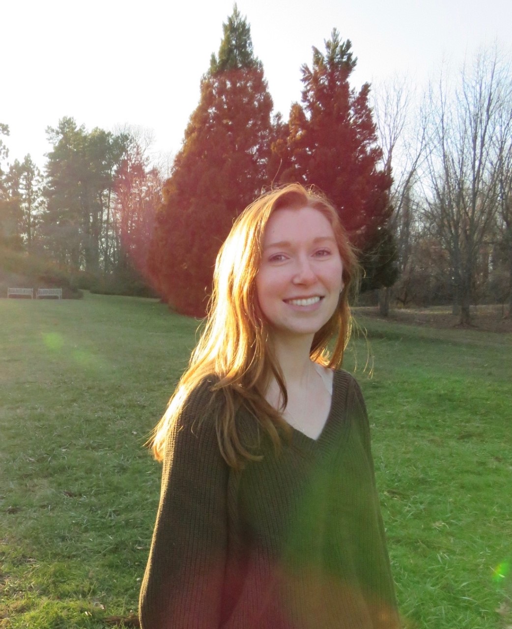 Gillian outside in a field with the sun shining