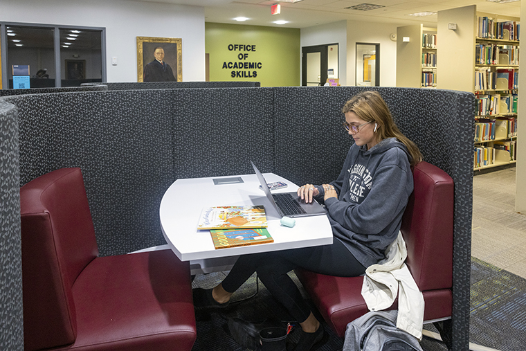 student working in the library