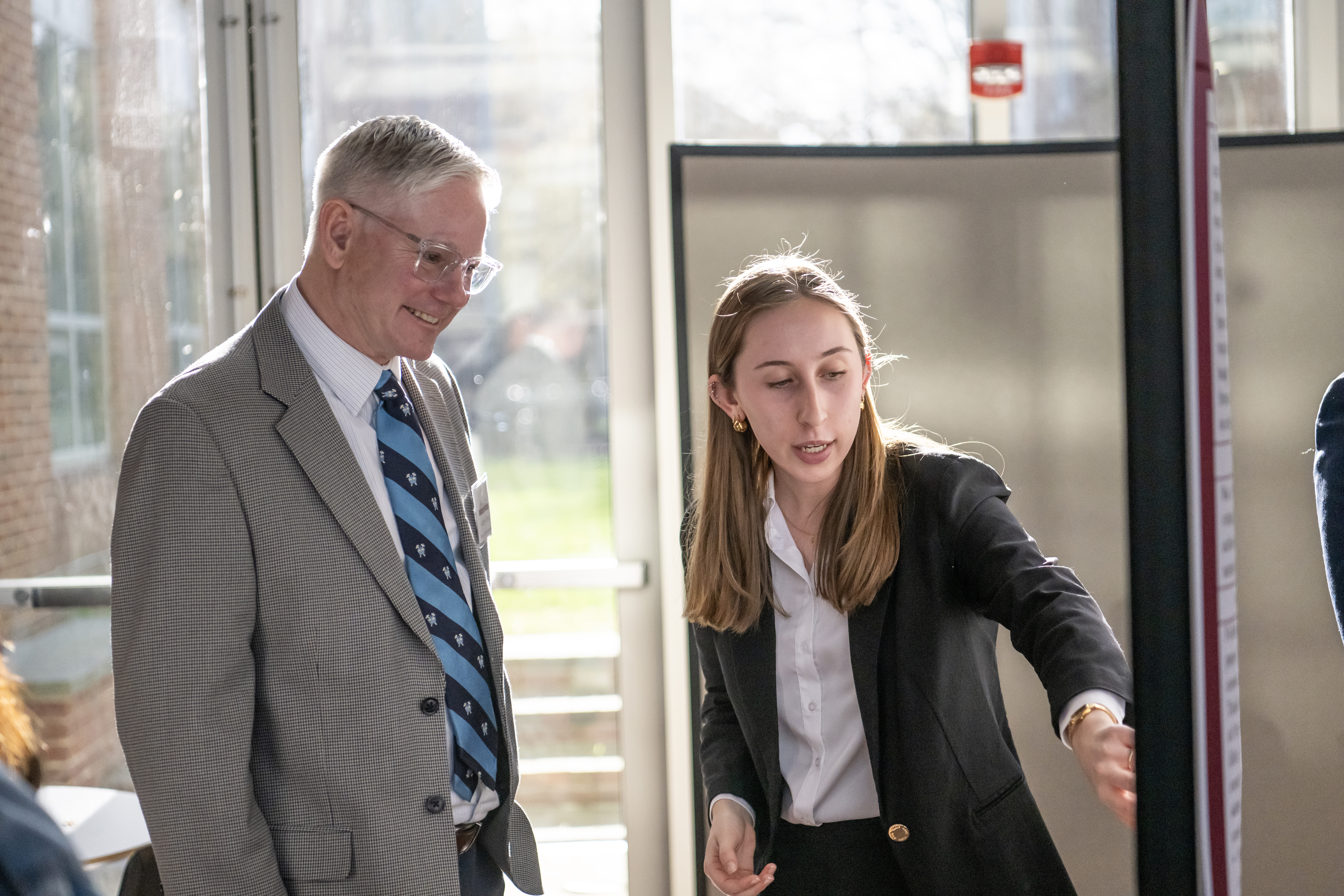 student presenting their senior capstone experience research to a professor